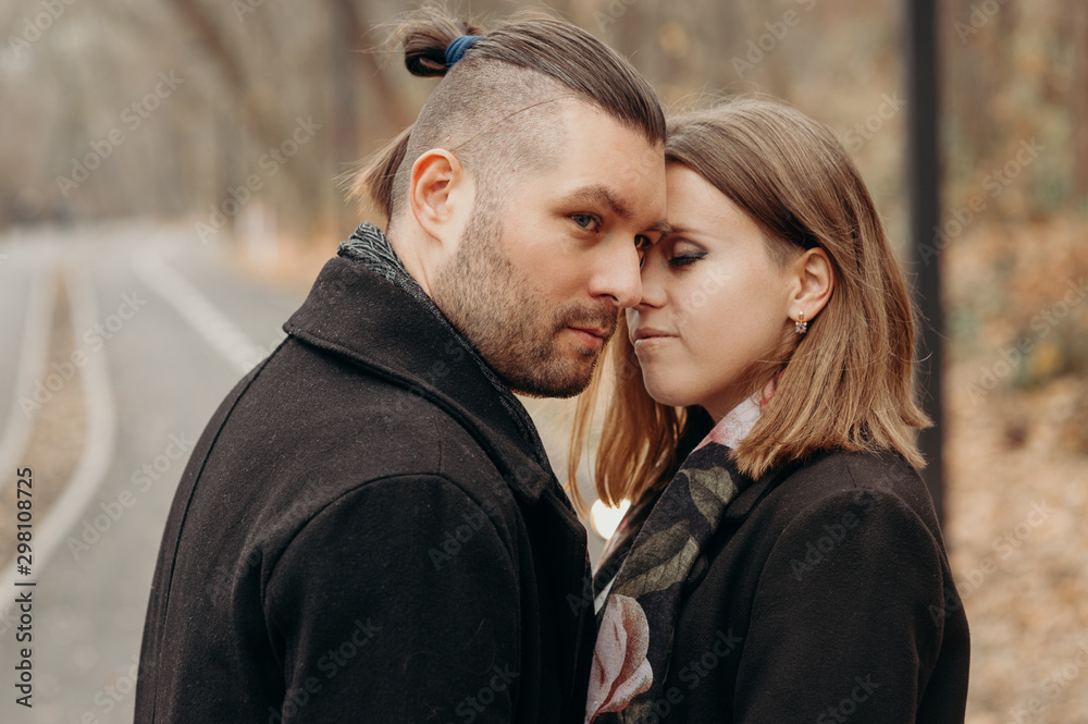Family story. Lovely couple hug and love outdoor. People dressing in black coat. Family story. Lovely couple hug and love outdoor. People dressing in black coat.