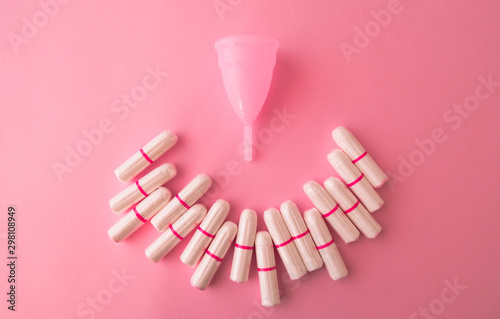 Vaginal cup and tampons on pink background. Flat lay