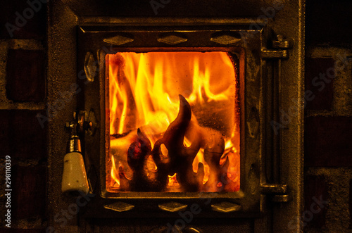 Wood burning inside the fireplace - traditional winter heating