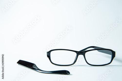 Broken bow near glasses on white background