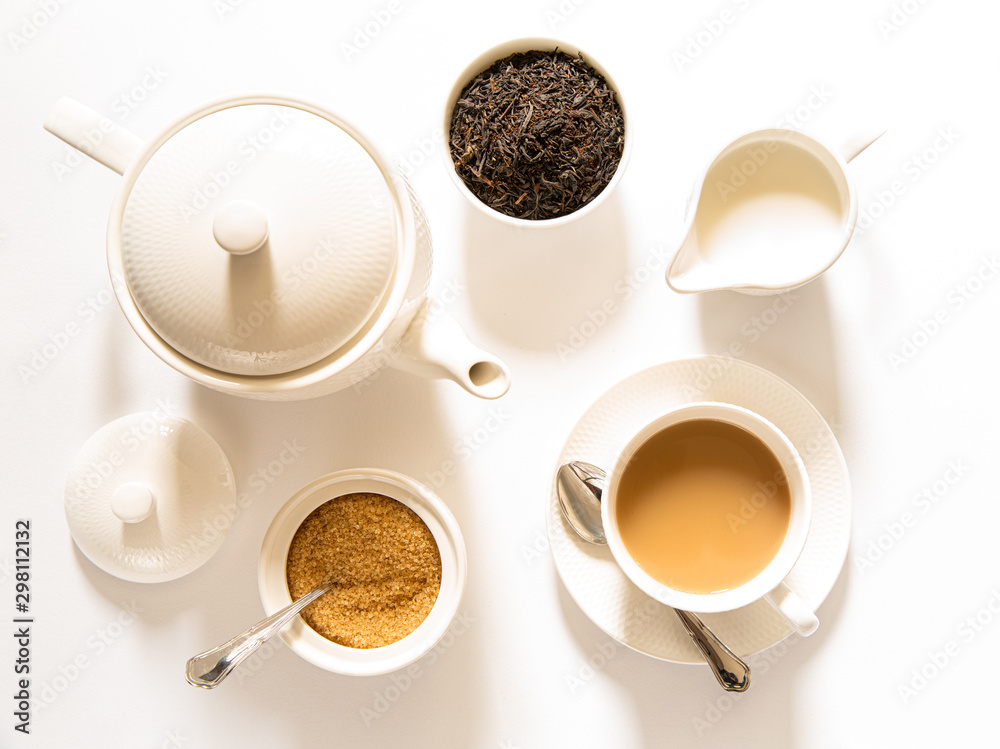 Traditional English breakfast black tea with milk tea leaves. teacup