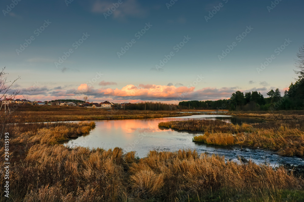 Autumn landscape by the river at sunset. Wonderful nature, beautiful natural background.