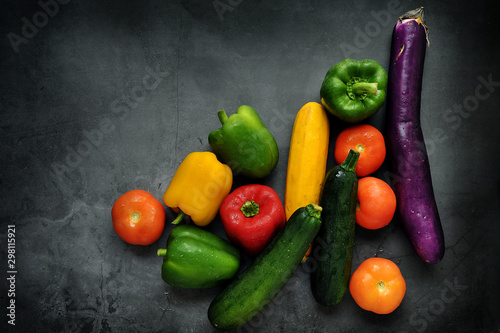 Colorful fresh mixed vegetables over black background with copy space