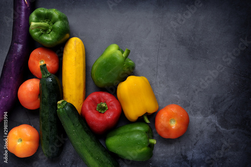 Colorful fresh mixed vegetables over black background with copy space