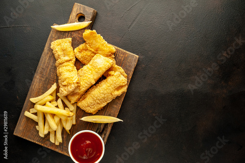 fish and chips with french fries, on a stone background  A photo