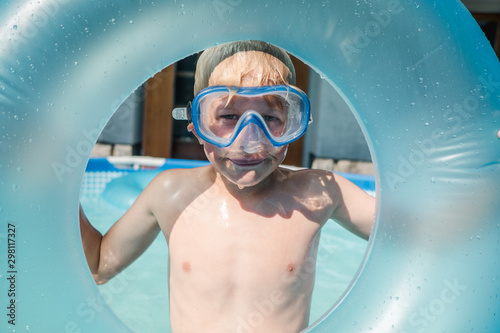 little boy with goggles in a kiddie pool