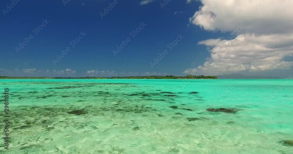 Drone Flying Over Shallow Crystal Clear Water and a View of a Tropical Island Drone Flying Over Shallow Crystal Clear Water and a View of a Tropical Island