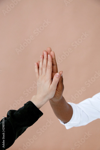 Folded black and white hands