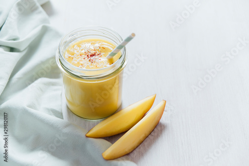 Drink: Mango Lassi in a glass, vegan with coconut yogurt photo