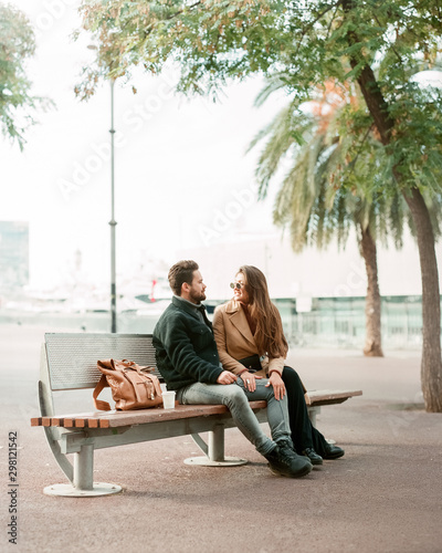 Wallpaper Mural young stylish couple is sitting on a bench and relaxing Torontodigital.ca