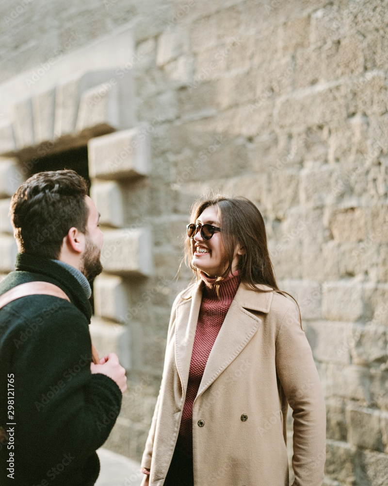 lively and natural frame, a girl with a guy are laughing at something and having fun. Beautiful young couple on a walk lively and natural frame, a girl with a guy are laughing at something and having fun. Beautiful young couple on a walk