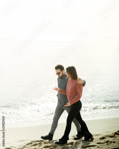 young couple walking along the sea promenade. Sunny clear weather