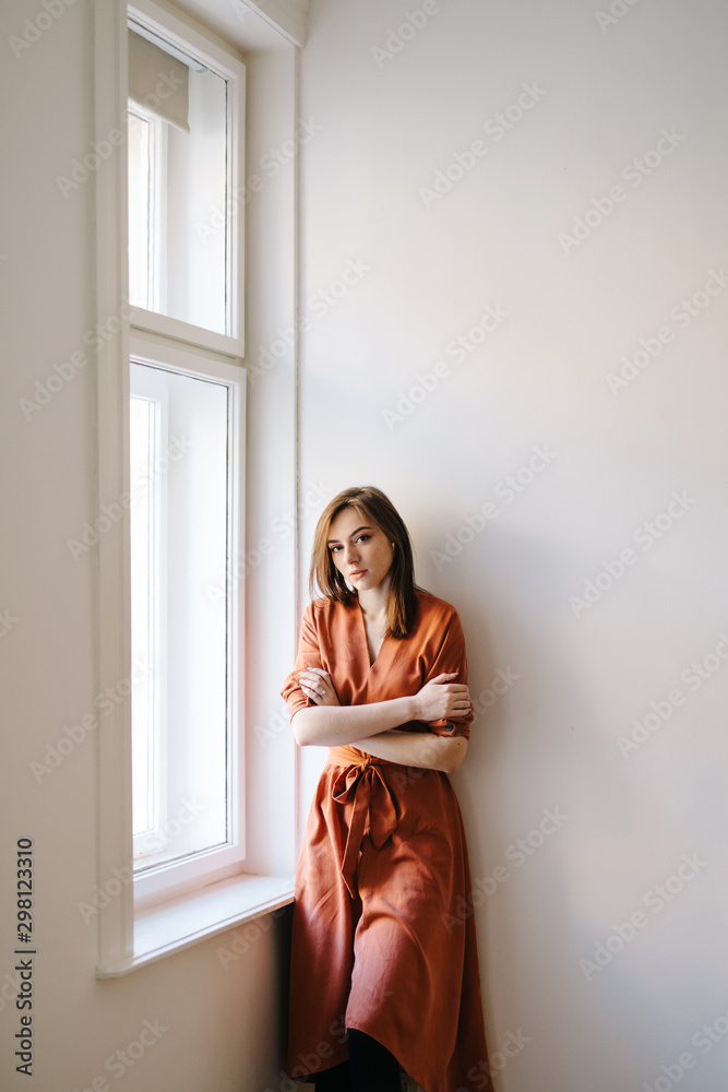 Beautiful woman standing near window Beautiful woman standing near window