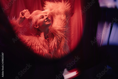 Specks of light near woman in fur jacket