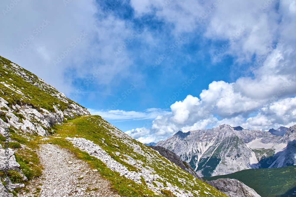 Mountain landscape with forest and blue sky in Austrian Alps. Tirol region