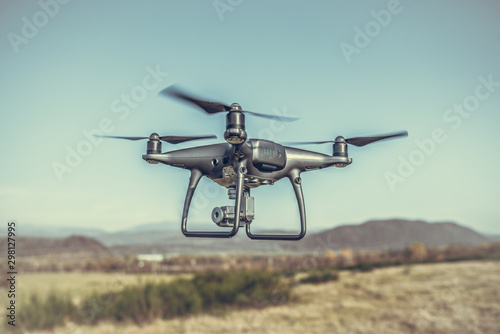 Fototapeta Naklejka Na Ścianę i Meble -  Drone in flight in the countryside. Drone in the air.