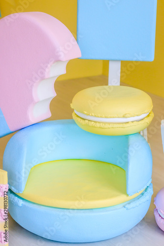 Children's holiday decoration. Holiday decoration. Sweet decorations on yellow background. Big sweets are decorative in the Studio.