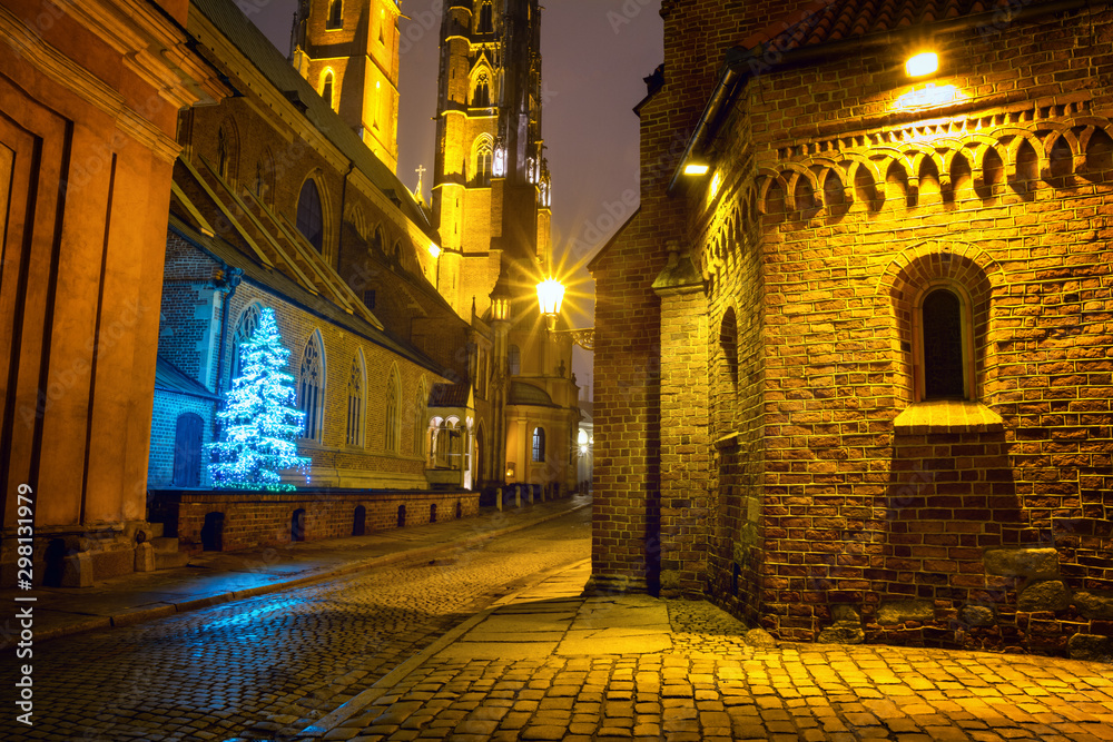 Christmas cityscape - evening view of the Cathedral of St. John the Baptist, located in the Ostrow Tumski old district of the city of Wroclaw, in Lower Silesia Province, Poland