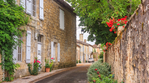 Fototapeta Naklejka Na Ścianę i Meble -  Summer city landscape - view of a medieval street in a provincial French town, in the historical province Gascony, the region of Occitanie of southwestern France