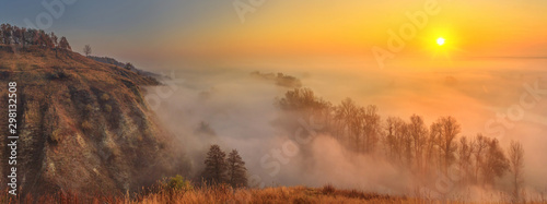 Fototapeta Naklejka Na Ścianę i Meble -  Autumn sunrise landscape, panorama, banner - view of a river valley covered with fog in the light of the sunrays, the northeast of Ukraine