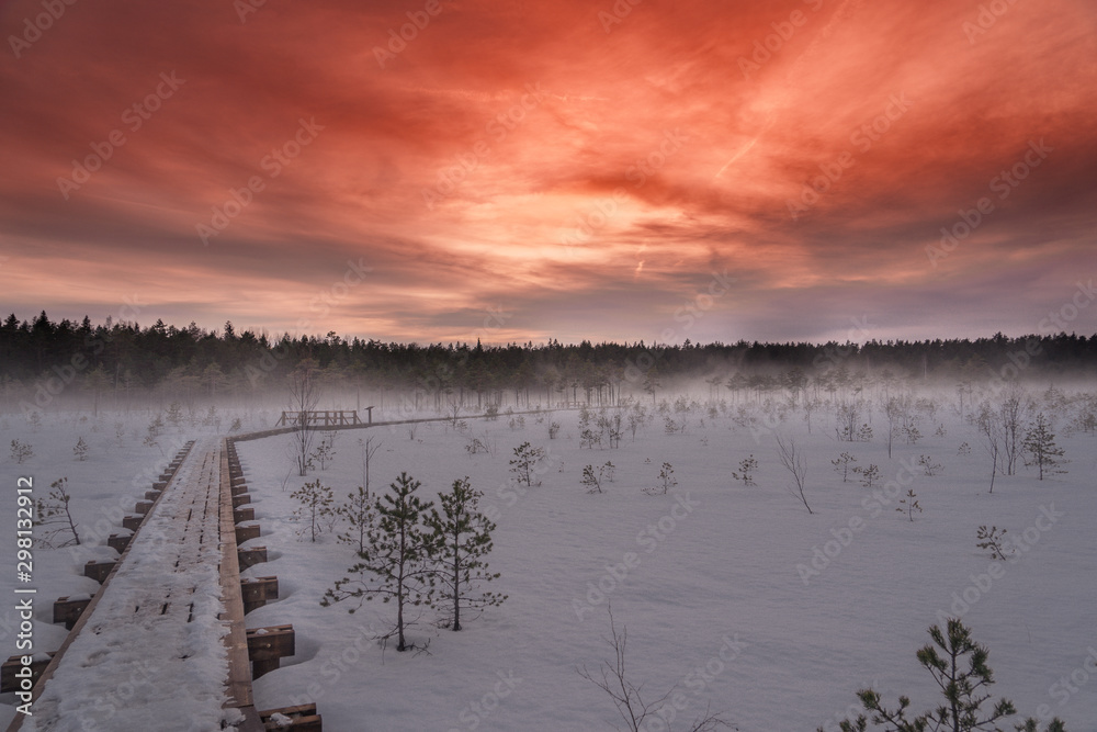 Peaceful scenery with a beautiful red sky, fog and wooden pathway. Peaceful scenery with a beautiful red sky, fog and wooden pathway.