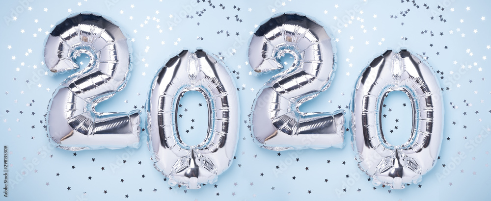 Silver balloons in the form of numbers 2020 and confetti on blue background. New year celebration. Happy New Year concepts - Image - obrazy, fototapety, plakaty 