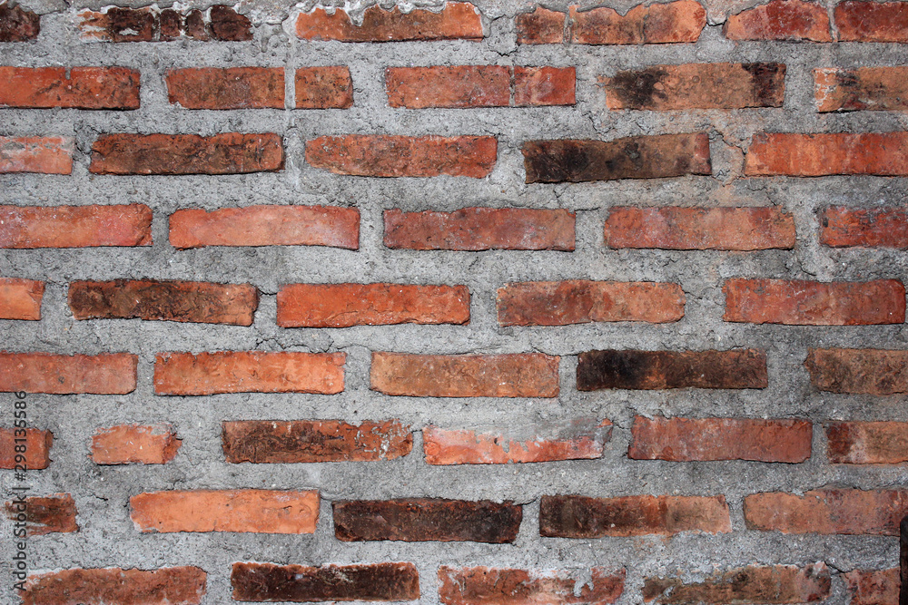 Naklejka premium Red brick and cement wall as a background