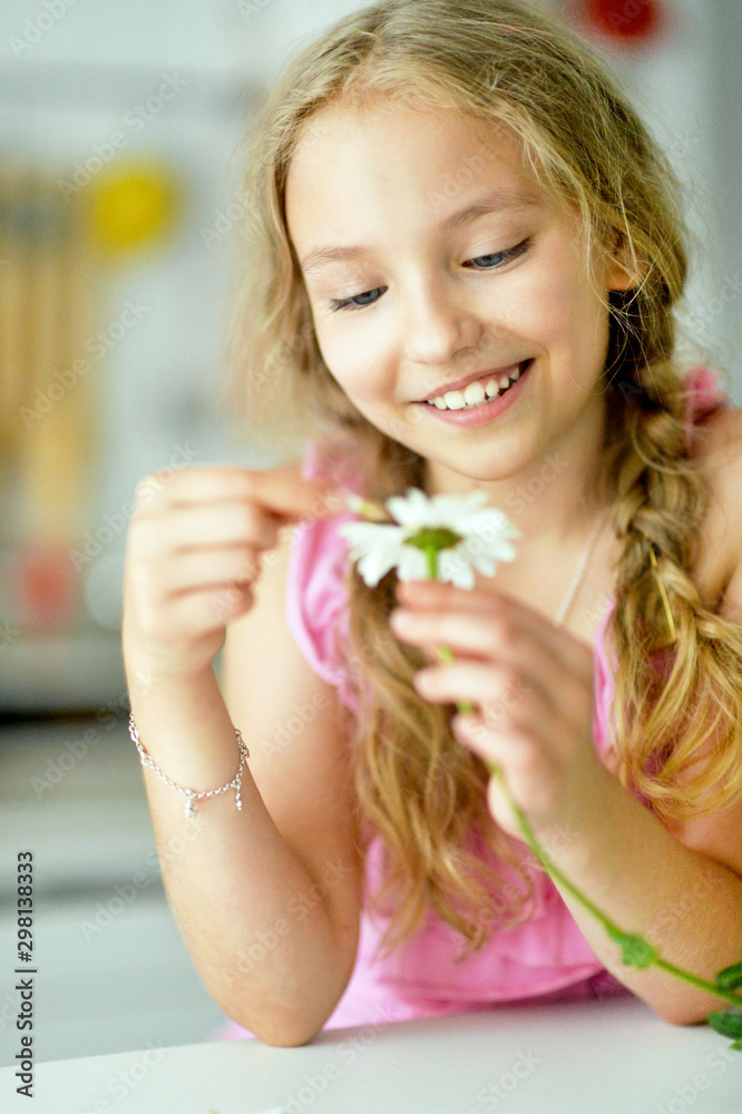 Close up portrait of beautiful teenage girl with daisy flower Close up portrait of beautiful teenage girl with daisy flower