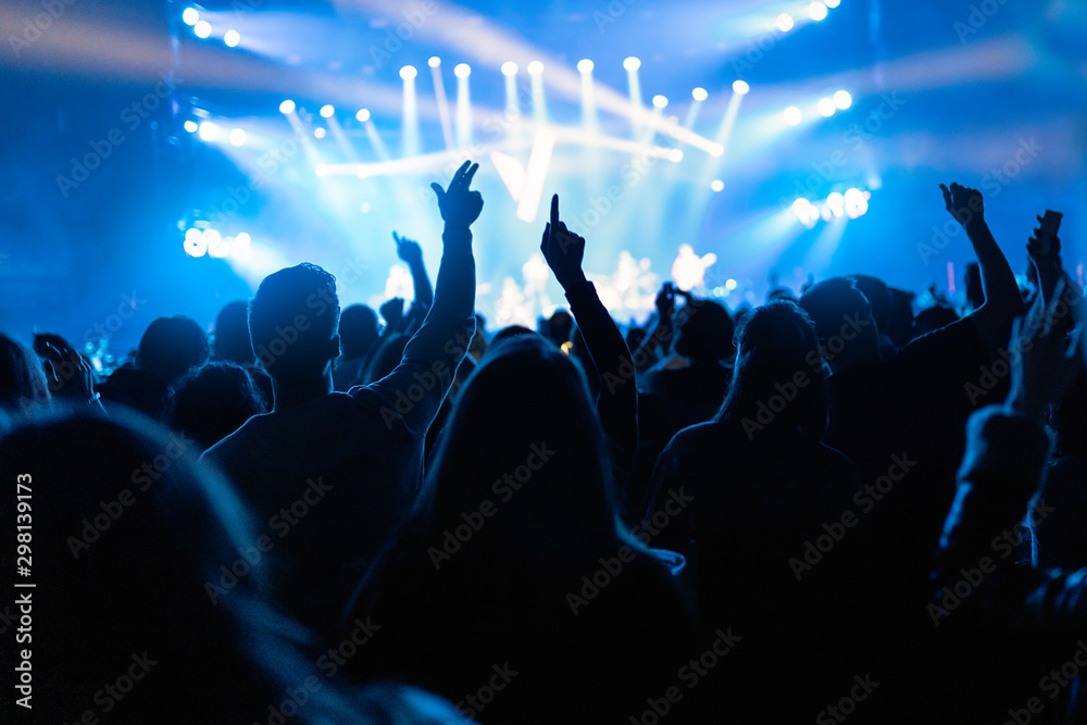 © Santi Nunez/Stocksy - Silhouettes of concert crowd in front of bright stage lights © Santi Nunez/Stocksy - Silhouettes of concert crowd in front of bright stage lights