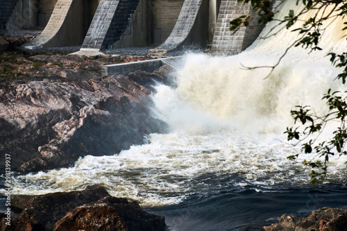 The rapid flow of water filling the canyon after the opening of the dam