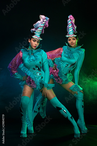 Photography Two beautiful go-go dancer girls in freak costumes on disco party in color smoke