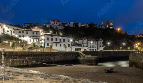 boat stranded on a beach of a small fishing village