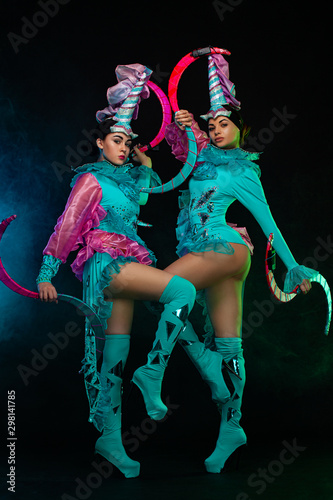 Photos Two beautiful go-go dancer girls in freak costumes on disco party in color smoke
