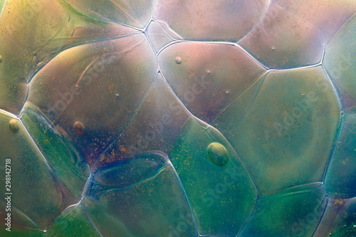 Closeup of the abstract colors, textures and patterns in the surface of a handmade glass globe (Christmas ornament)