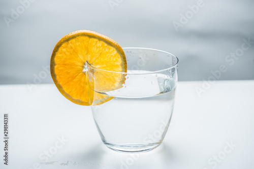 Glass of pure water with citrus fruit