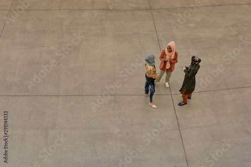 Contemporary Muslim Women On Concrete floor. photo