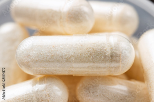 White medical capsules of glucosamine chondroitin, healthy supplement pills, macro image photo