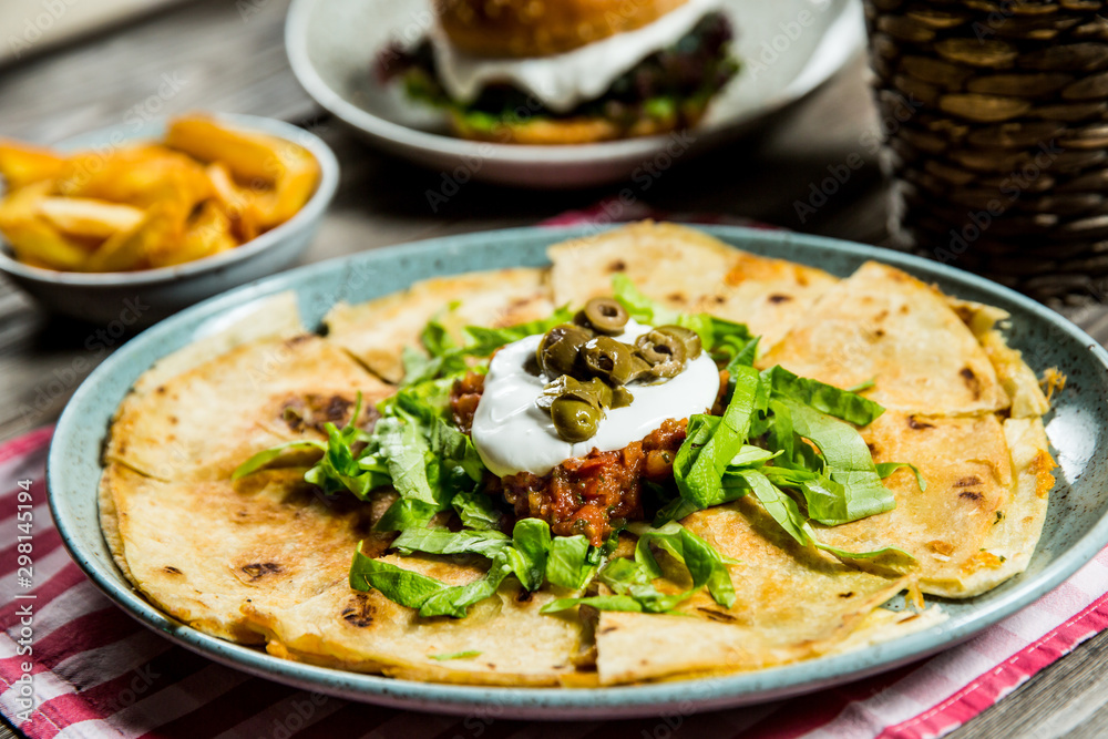 tortilla with tomato sauce, olives and sour cream tortilla with tomato sauce, olives and sour cream