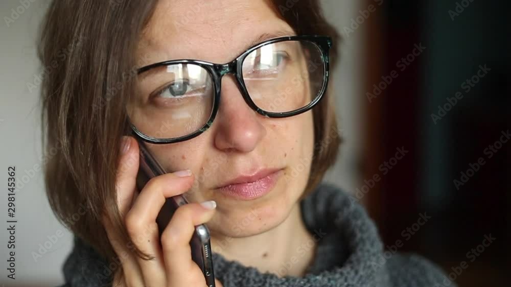 Close-up of a woman's face talking on a cell phone. Close-up of a woman's face talking on a cell phone.