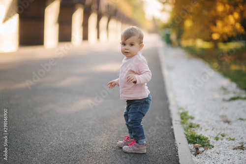 Adorable little girl walk in the parl in october. Cute ten month baby walk. Beautiful happy girl. Autumn mood © Aleksandr