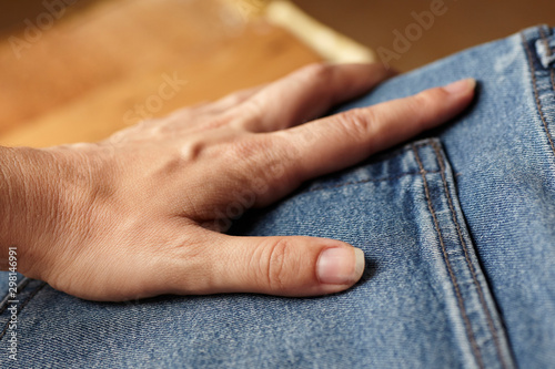 the girl put her hand in the pocket of my jeans. the blue jeans fabric details
