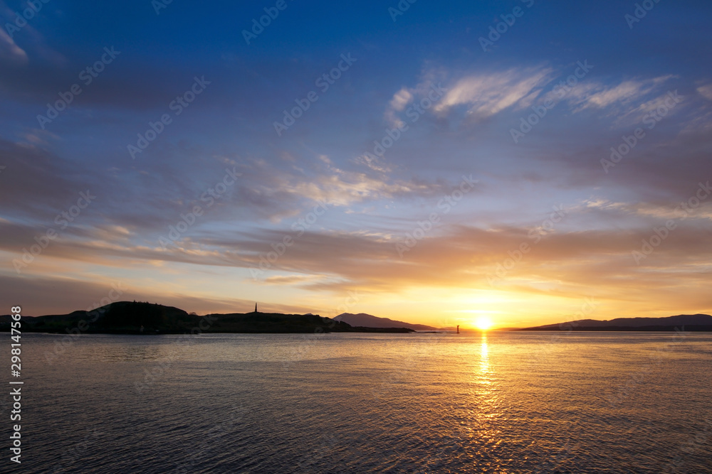 Sunset over Oban Bay and the entrance to Oban harbour. In the background is the island of Kerrera