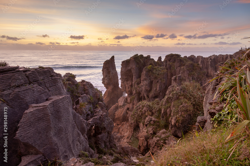 Pancake Rocks in Punakaiki, New Zealand, at sunset. Limestone formation overlooking the ocean.