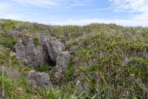 Pancake Rocks in Punakaiki, New Zealand. Limestone formation overlooking the ocean in Paparoa National Park. photo