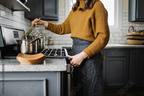 Woman Stiring Soup on the Stove photo