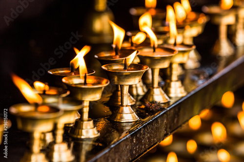 Close up of illuminated oil lamps