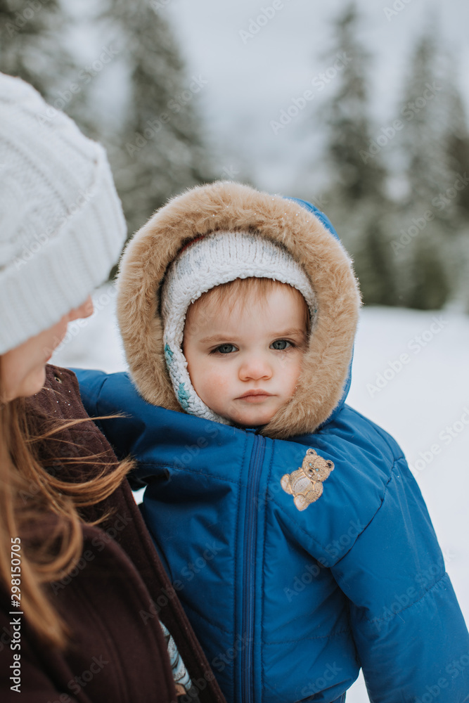 Mother Holding Toddler in Outdoor Winter Landscape Mother Holding Toddler in Outdoor Winter Landscape
