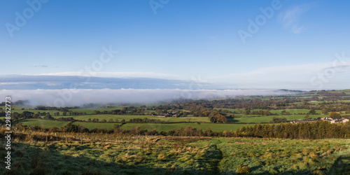 Fog and mist roll over the land below Beacon Fell Country Park seen on a cold October morning in 2019.