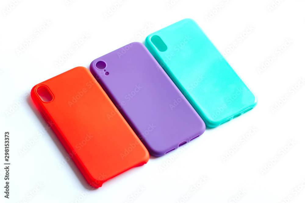 Mint, red and purple cases for the smartphone on the white background. Protective silicone cases for smartphone. Colorful silicone cases for your smartphone. Isolated image, selective focus. Mint, red and purple cases for the smartphone on the white background. Protective silicone cases for smartphone. Colorful silicone cases for your smartphone. Isolated image, selective focus.