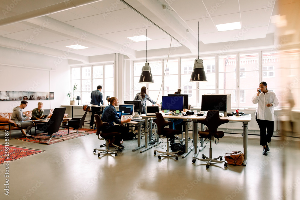 Male and female entrepreneurs working in creative office Male and female entrepreneurs working in creative office